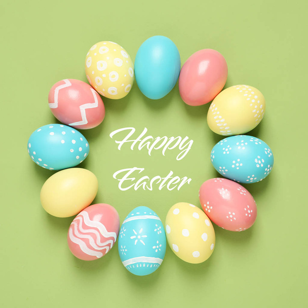 Frame made of colorful painted eggs and text Happy Easter on color background, top view  - Zdjęcie, obraz