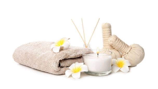 Beautiful spa composition with candle and herbal bags on white background - Photo, Image