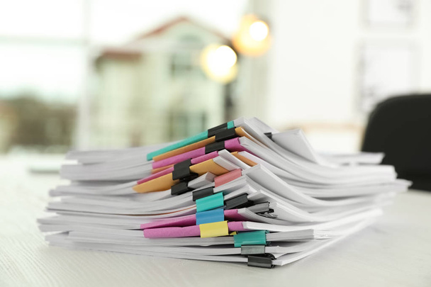 Stack of documents with paper clips on office table - Fotoğraf, Görsel