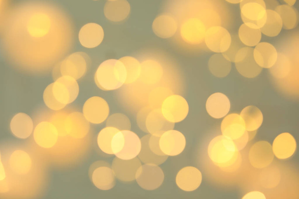 Blurred view of shiny gold lights. Bokeh effect - Foto, immagini