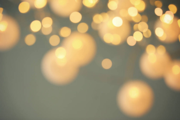 Blurred view of shiny gold lights. Bokeh effect - Photo, Image
