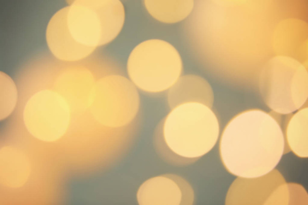 Blurred view of shiny gold lights. Bokeh effect - Photo, image