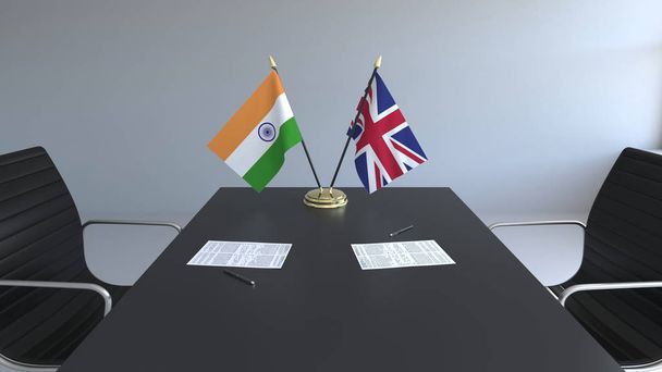 Flags of India and Great Britain and papers on the table. Negotiations and signing an international agreement. Conceptual 3D rendering - Foto, Bild