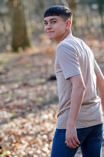 Teenage boy outside on a bright Spring day - Foto, afbeelding