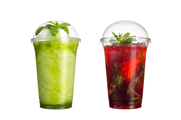 Delicious fruit smoothies in plastic cups, on a white background. Two cocktails with a taste of kiwi and berry mojito. - 写真・画像
