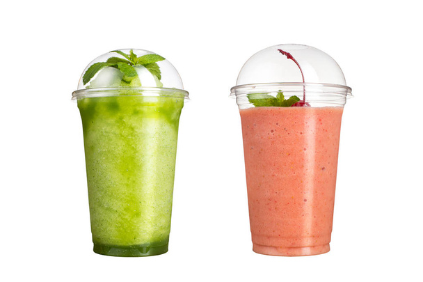 Delicious fruit smoothies in plastic cups, on a white background. Two cocktails with a taste of kiwi and cherry. - 写真・画像