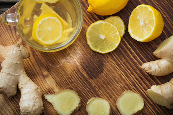 ginger and lemon tea on wooden background - Φωτογραφία, εικόνα