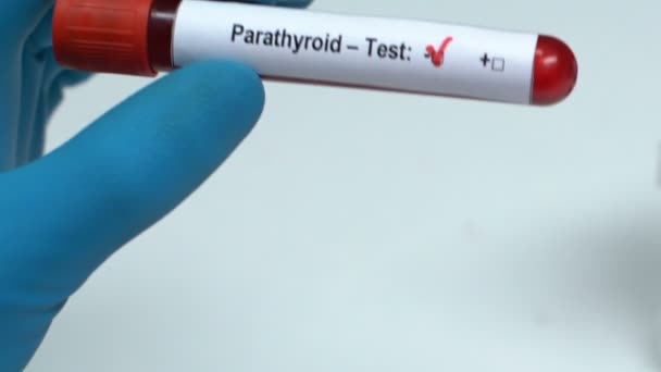 Parathyroid, doctor holding blood sample in tube close-up, health check-up - Filmati, video