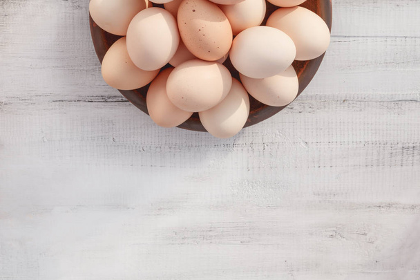 Farm fresh organic brown chicken eggs from free range chickens over a rustic wooden background - 写真・画像
