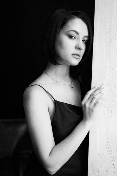  Beautiful Young Woman Posing in black  dress in studio - Foto, immagini
