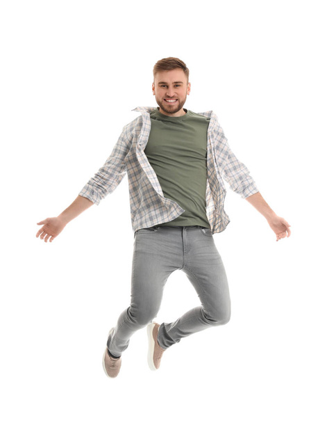 Jumping young man on white background - Fotó, kép