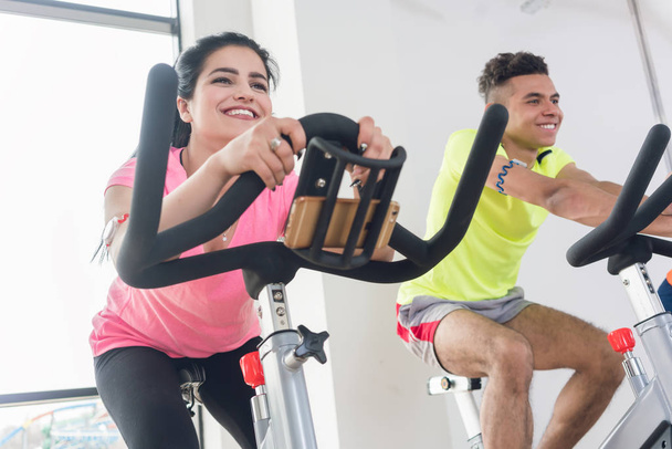 Two friends cycling at gym - Photo, Image