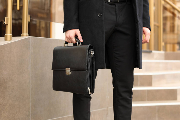 Businessman with stylish briefcase on city street - Photo, Image