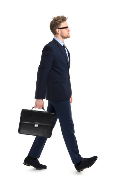 Going businessman with stylish briefcase on white background - Foto, imagen