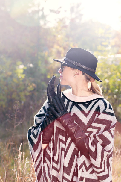 woman in poncho, hat and long gloves - Photo, Image