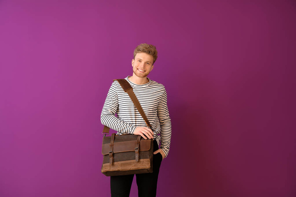 Handsome man with stylish briefcase on color background - Fotó, kép