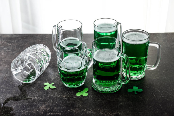 Mugs of green beer on table. St. Patrick's Day celebration - Photo, Image