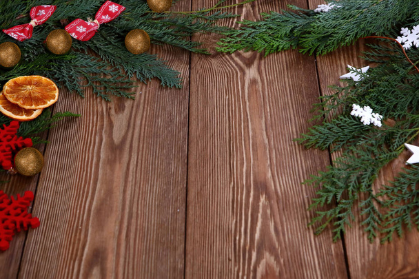 Christmas composition on brown wooden background - Photo, Image