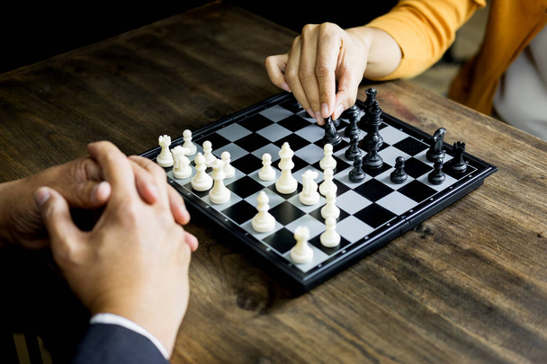 hand of businessman moving chess figure in competition board gam - Photo, Image