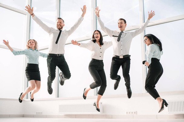 very happy business team rejoices in the spacious office - Photo, image