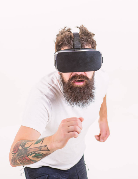 Virtual race. Man bearded gamer VR glasses white background. Virtual reality game concept. Cyber sport. Guy with head mounted display interact virtual reality. Hipster play virtual sport game - Photo, Image
