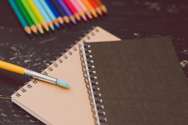 notebooks with colorful pencils and art supplies - 写真・画像
