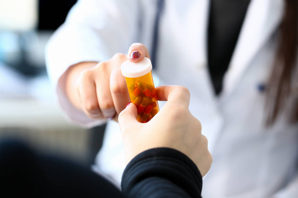 Female medicine doctor hand hold jar of pills and - Foto, Imagen