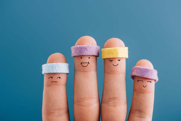 cropped view of happy sportive fingers in headbands isolated on blue - Photo, Image