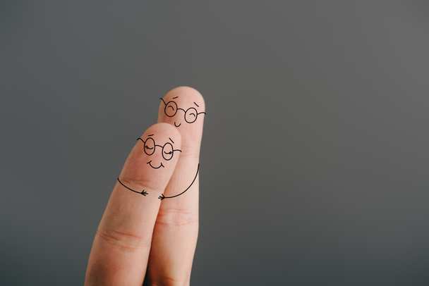 partial view of smiling couple of fingers hugging isolated on grey - Foto, Bild