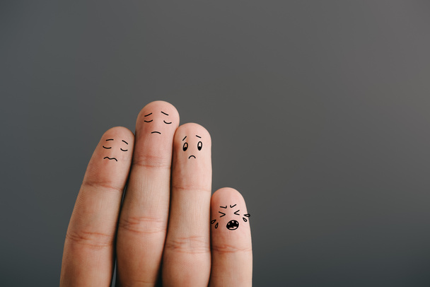 cropped view of sad fingers family with crying kid isolated on grey - Foto, Imagem