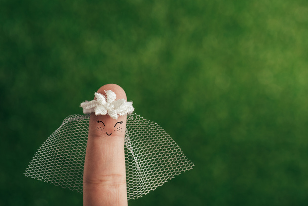 cropped view of finger as happy bride on green - Fotografie, Obrázek