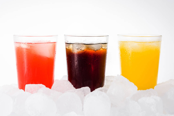 Colorful soft drinks for summer with ice cubes on white background - Photo, Image