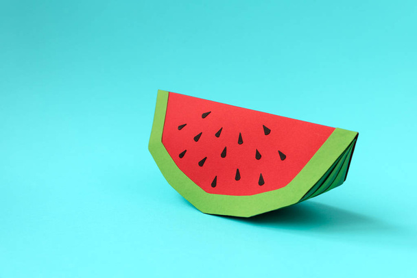 Paper watermelon slice on blue pastel background. Creative idea. Art food concept. - Zdjęcie, obraz
