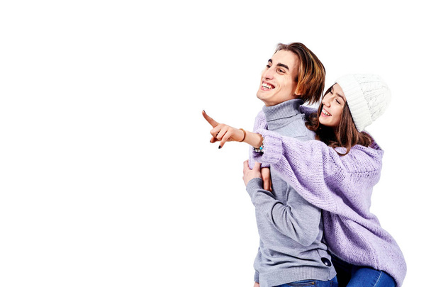 Image of lovely couple having fun while man piggybacking his girlfriend isolated on white background - Фото, зображення
