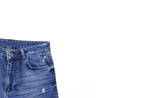Blue jeans isolated on white background top view flat lay. Detail of nice blue jeans. Jeans texture or denim background. Trend clothing. Beauty and fashion, clothing concept. - Fotó, kép