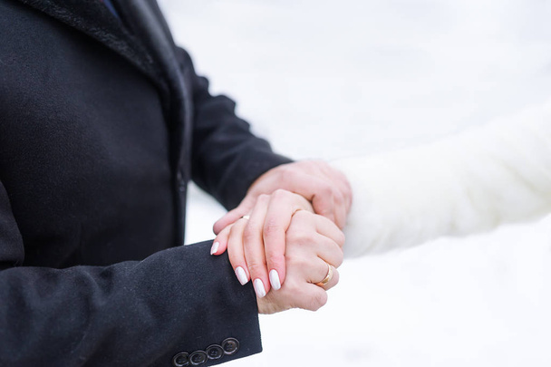 Groom and bride hands with rings. Groom and bride hand to hand  - Foto, Imagen