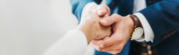 selective focus of man and woman shaking hands at office  - Photo, Image