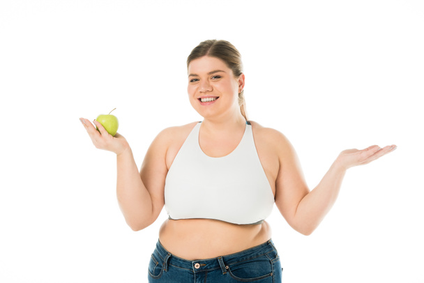 happy smiling overweight woman holding green apple isolated on white - Valokuva, kuva