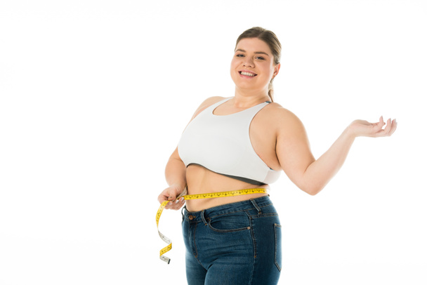χαμογελαστά υπέρβαρη γυναίκα μέτρηση μέσης με μεζούρα που απομονώνονται σε λευκό, θετικότητα έννοια σώματος - Φωτογραφία, εικόνα