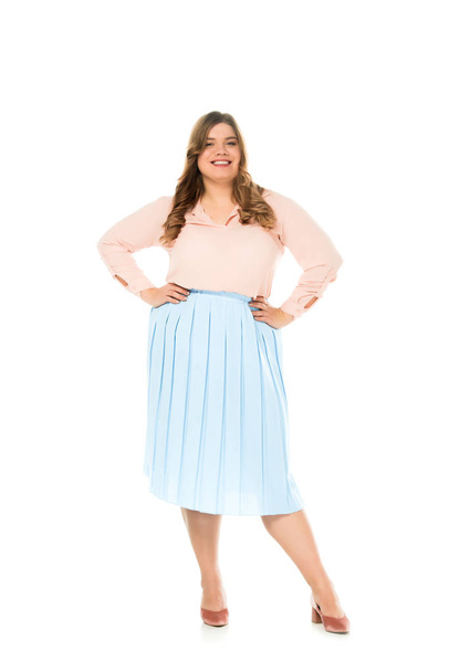 sorridente felice donna in sovrappeso in elegante abbigliamento posa con le mani sui fianchi isolato su bianco
 - Foto, immagini