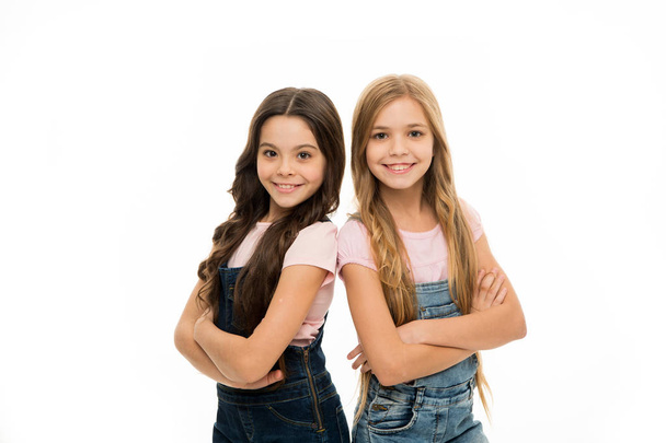 Hair like this is the focus of their look. Beauty and hair salon. Cute little girls wearing new hairstyle. Small girls with long hairstyle. Kids hair grooming. Natural hair styling and dressing - Foto, Imagen