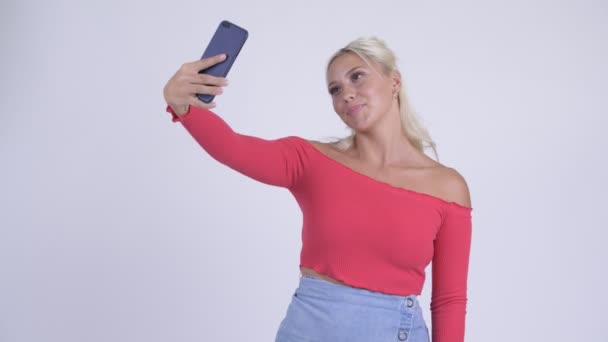 Happy young beautiful blonde woman taking selfie - Záběry, video