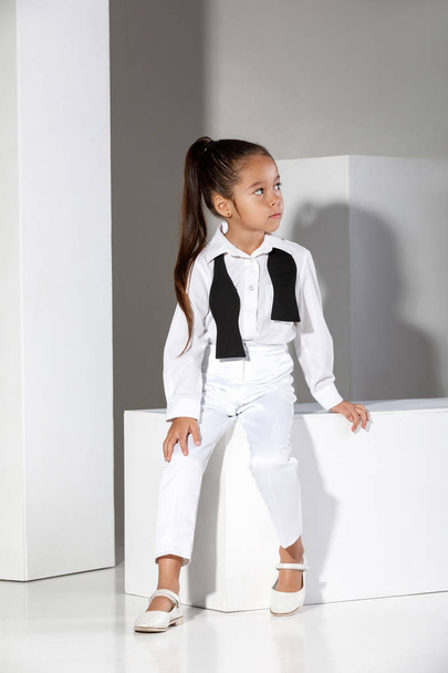fashion little girl model in a white suit and bow tie - Foto, Bild