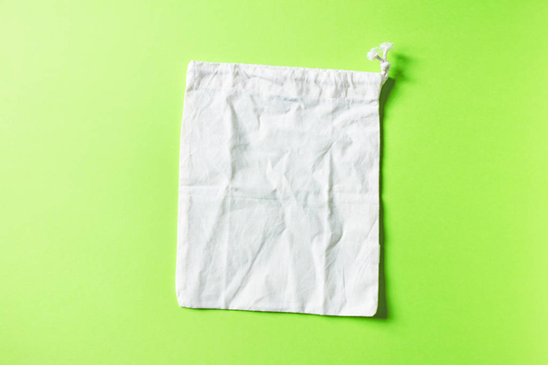 Empty cotton bags on green background - Foto, Imagem