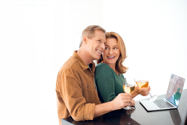 happy couple clinking glasses of white wine on white background - Fotoğraf, Görsel