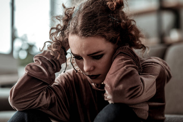 Curly teenage girl with dark makeup feeling bad after divorce of parents - Foto, Imagen