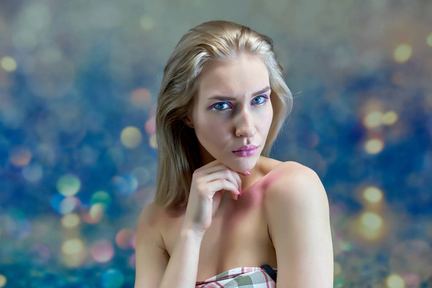 Close-up portret concept van een mooi blond meisje op een veelkleurige achtergrond. Haar ontwikkelt zich in verschillende richtingen. - Foto, afbeelding