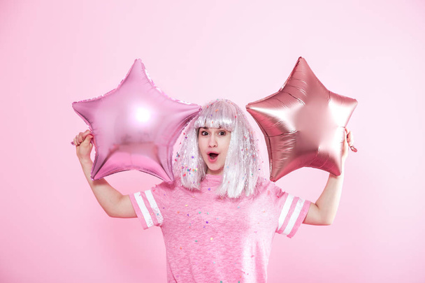 Funny Girl with silver hair gives a smile and emotion on pink ba - Photo, Image