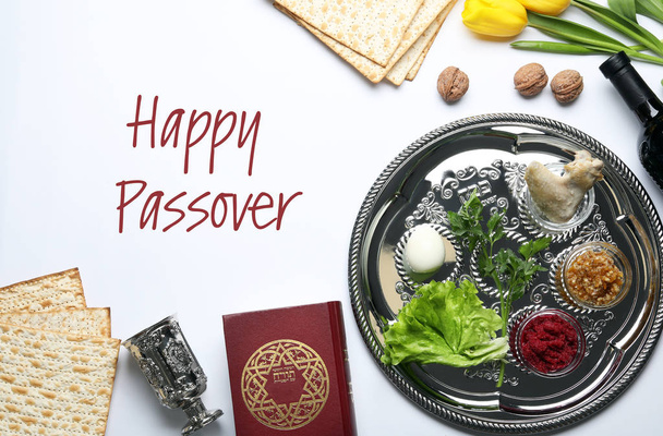 Flat lay composition of symbolic Pesach items on white background. Happy Passover - 写真・画像