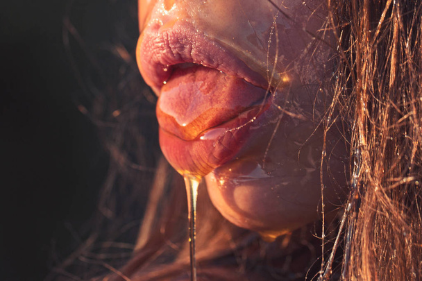 closeup of female sexy mouth with honey - Fotoğraf, Görsel
